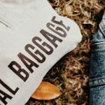 person in white and black shirt and blue denim jeans